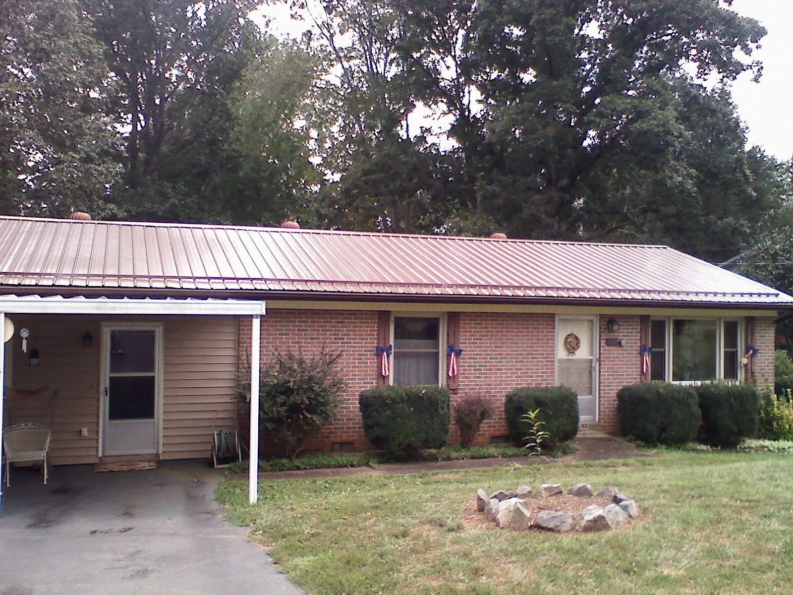 Bronze metal roof and carport on a brick ranch home — Roof Repair work by our crew in Cecil